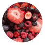 A close-up circular photo of mixed berries, including red raspberries, blackberries, blueberries, and sliced strawberries, filling the frame.