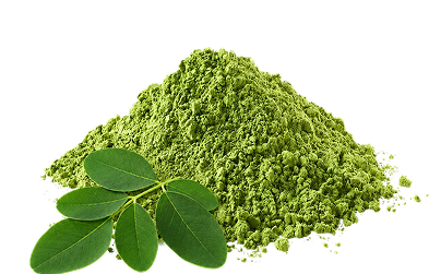 A pile of bright green powder with two fresh green leaves on a plain white background.